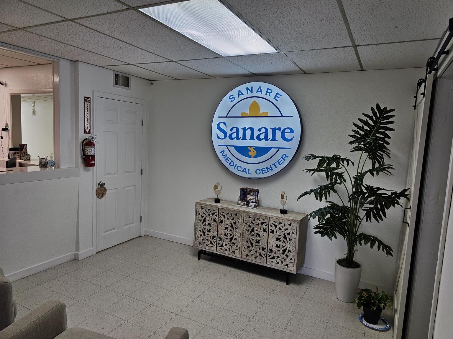 Sanare Medical Center reception and illuminated logo